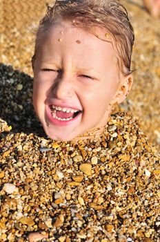 funny screaming boy on the beach in sand 
