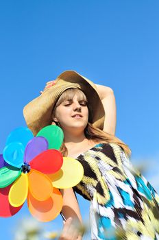 girl with windmill over the blue clear sky