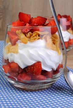 Dessert of strawberries with whipped cream and corn flakes