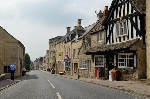 Painswick, UK – August 28, 2013: New Street, Painswick, in the Cotswolds, with the oldest post office of England in the half-timbered house on August 28, 2013.