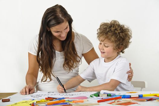 Mother teaches her child how to draw