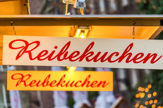 Shield on a Christmas market with the inscription potato pancakes.