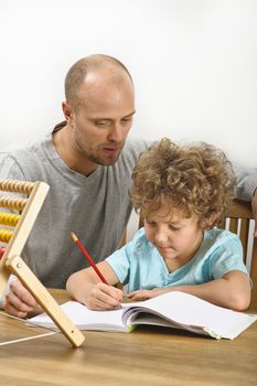 father helping his son with his homework