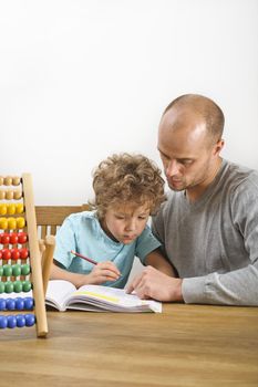 father helping his son with his homework