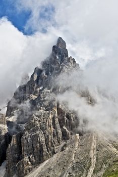 portrait of Dolomites, details of Pale di San Martino with clouds around in summer season seen from Rolle Pass, Trentino - Italy