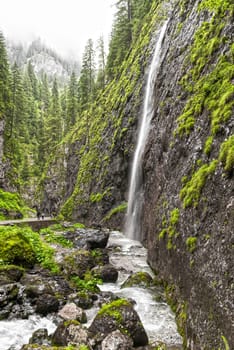 waterfall in the Sottoguda gorges in a rainy summer day, Dolomites, Veneto, Italy