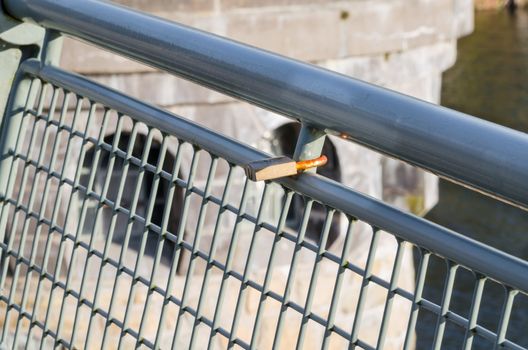 Love confirmation padlock on a bridge railing.