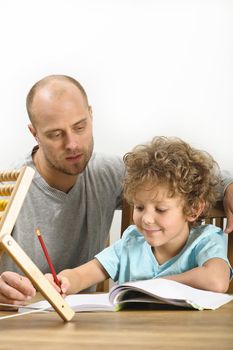 father helping his son with his homework