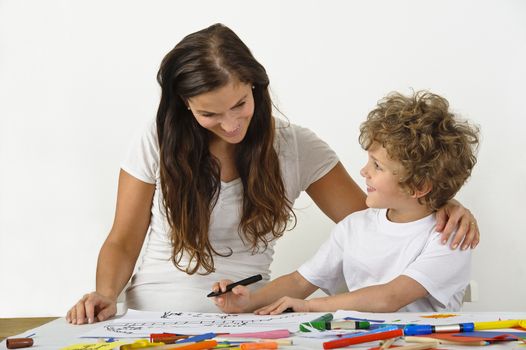 Mother teaches her child how to draw