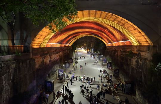 SYDNEY, AUSTRALIA - MAY 23, 2015;  View down into Argyle Street The Rocks as public watch, photograph or video  Life Story light show with narration by David Attenborough for Vivid Sydney. People in motion