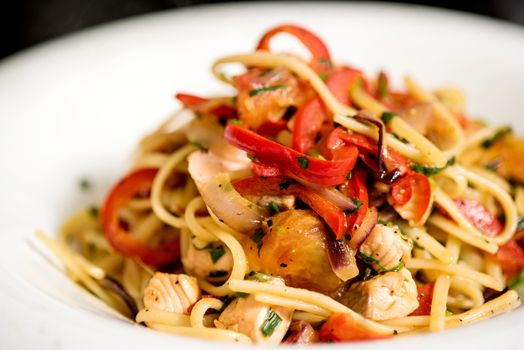 Close up of pasta with chicken and arugula