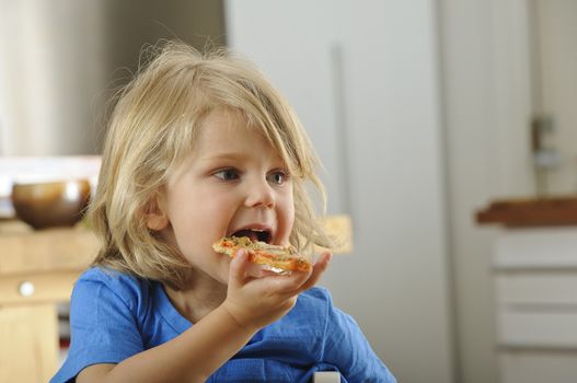Young boy enjoys a slice of pizza