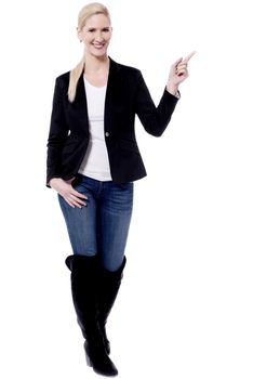 Trendy woman pointing her finger to copy space