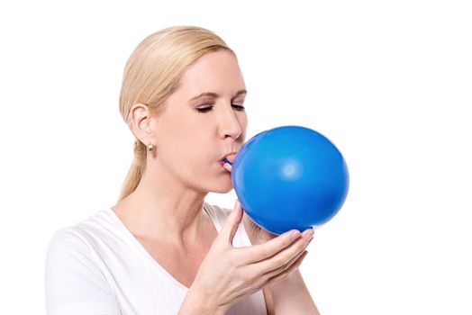 Woman inflating balloon for a party