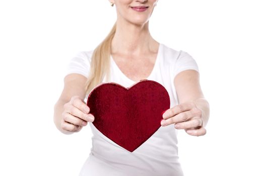 Cropped image of woman showing heart shape gift box