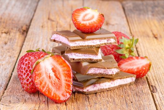 chocolate with strawberry cream on wooden background
