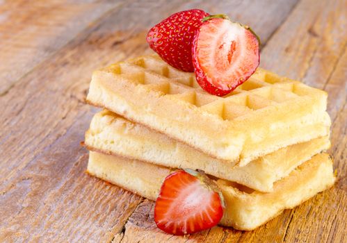 homemade waffles with strawberries  on wooden background
