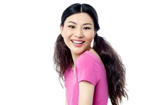 Cheerful girl looking at camera over white