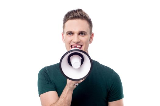 Young man advertising with megaphone