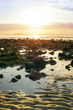 reflections at rocky beal beach near ballybunion on the wild atlantic way ireland with a beautiful yellow sunset