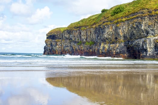 lone kayaker near the cliffs of ballybunion beach on the wild atlantic way ireland