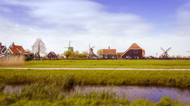 Windmills and rural houses in Zaanse Schans, Netherlands. Tilt-shift effect and Color filter effect