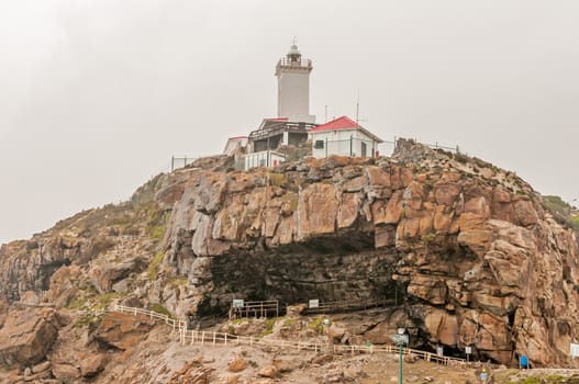 MOSSELBAY, SOUTH AFRICA - DECEMBER 27, 2014: The Cape St. Blaize lighthouse at The Point. The cave below the lighthouse is an important archaeological site