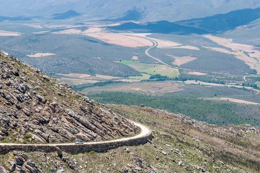 SWARTBERG PASS, SOUTH AFRICA - JANUARY 2, 2015: View from the Swartberg Pass to the East showing farms down in the valley. The pass is a declared national monument.