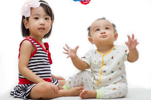 Two Asian Chinese  children playing in white background