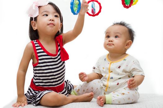 Two Asian Chinese  children playing in white background