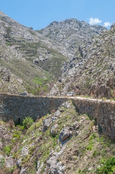 SWARTBERG PASS, SOUTH AFRICA - JANUARY 2, 2015: Built out part of the historic Swartberg (Black Mountain) Pass showing the intricate stonework. The pass is a declared national monument.