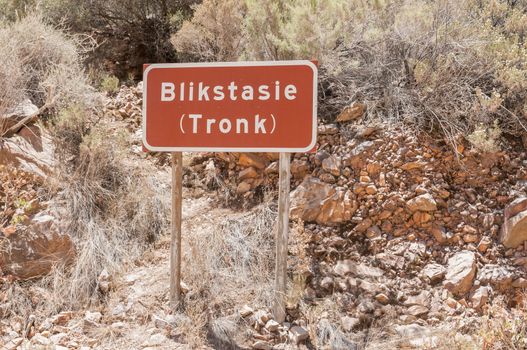 SWARTBERG PASS, SOUTH AFRICA - JANUARY 2, 2015: Sign at the ruins of the Blikstasie (old jail) in the historic Swartberg (Black Mountain) Pass. The pass is a declared national monument.