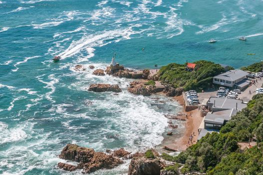 KNYSNA, SOUTH AFRICA - JANUARY 5, 2015: The restaurant and parking area at The Heads in the Knysna lagoon. A speedboat is on its way to The Heads