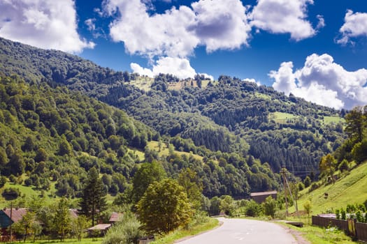 mountain road with mountains and clouds