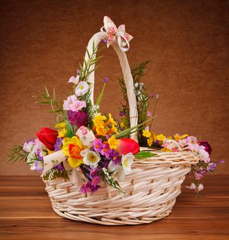 basket decorated with flowers on wooden table