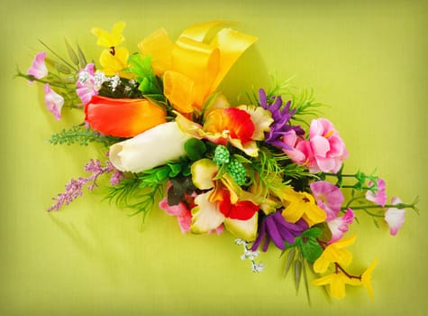 artificial flower arrangement on a yellow background with blank  for advertisement