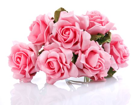 artificial bouquet of pink roses on a white background