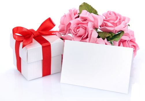 Greeting card with pink flowers and a gift box with red ribbon and bow on a white background
