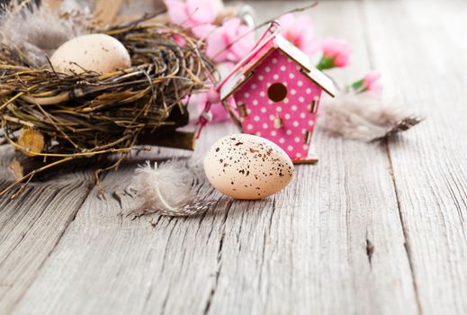 easter decoration on wooden background with color egg and with birdhouse,