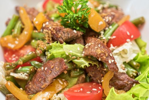 Warm salad with veal closeup