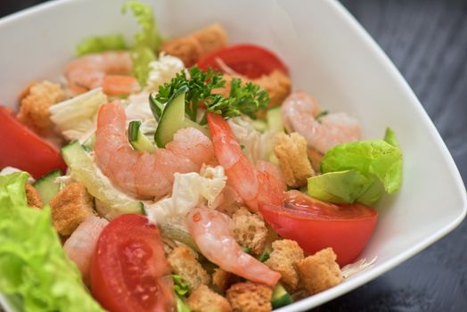 Caesar shrimp salad with cheese and arugula