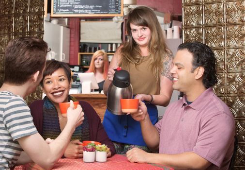 Group of happy customers being served coffee by waitress