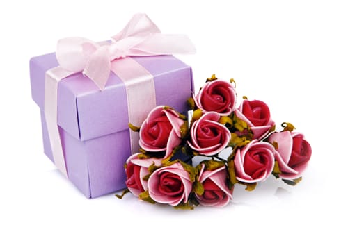 red flowers and purple gift box with pink ribbon on white background