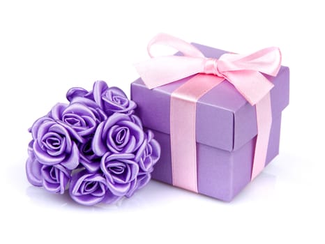 violet flowers and violet gift box with pink ribbon on white background