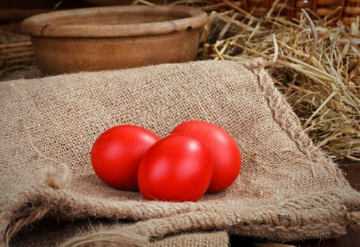 three red easter eggs at home backgraund