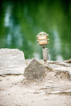 mood lighting light fixture on rocks by the water