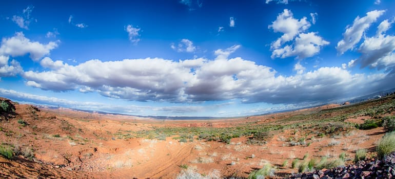 panorama of a valley in utah desert with blue sky