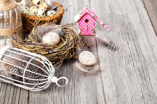 easter decoration on wooden background with color egg and with birdhouse,