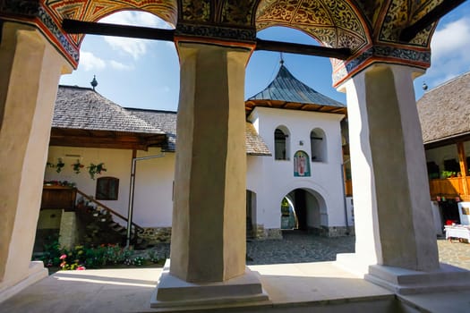 Polovragi, Romania - September 2, 2012: Inside view of the old orthodox Polovragi monastery seen trough a colonade, Romania