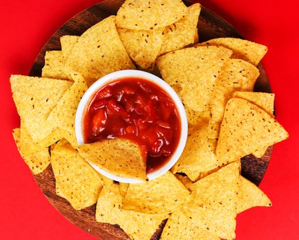 Potato chips with sauce on a red background